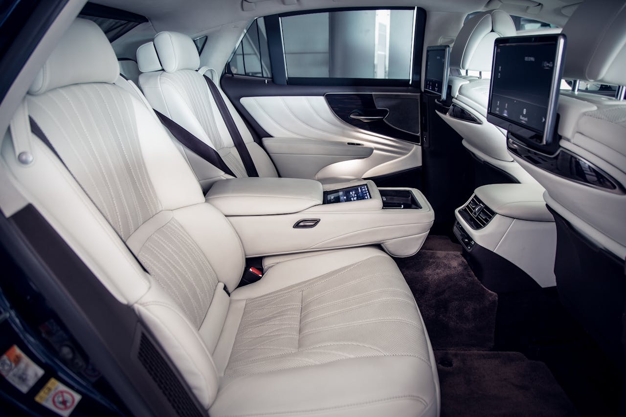 Explore the elegant and comfortable back seat interior of a luxury car with high-end features.
